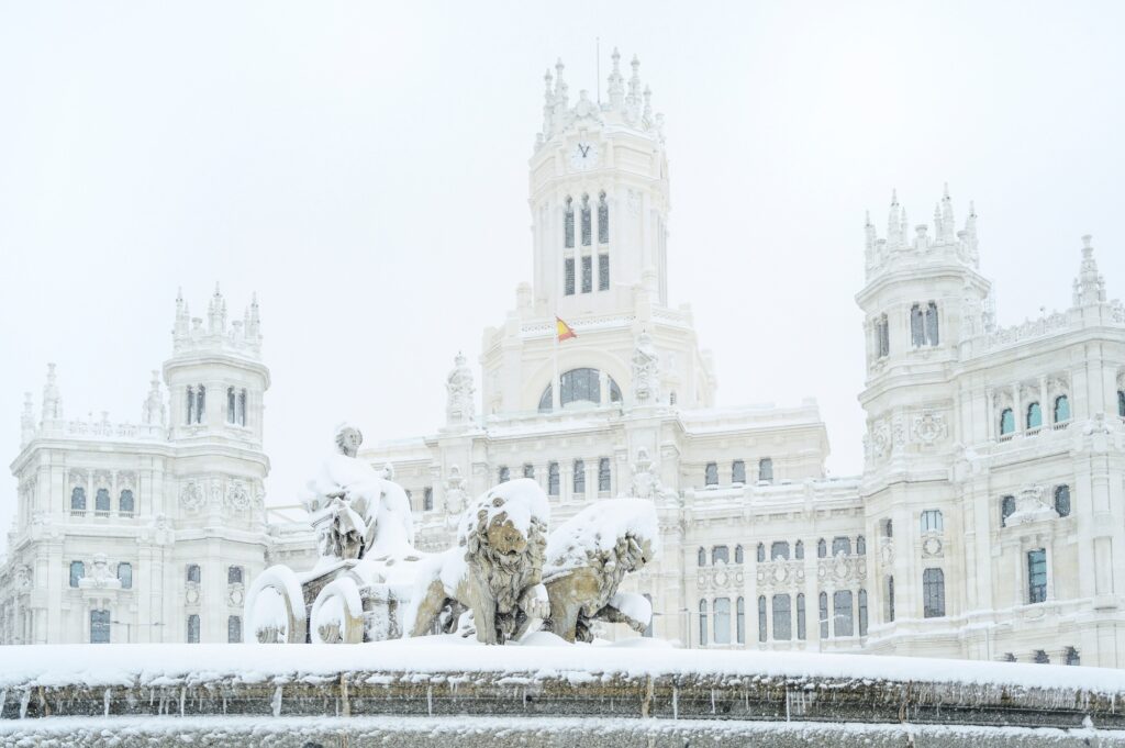 Fountain of the Plaza de Cibeles in Madrid covered with snow after the passage of the storm Filomena