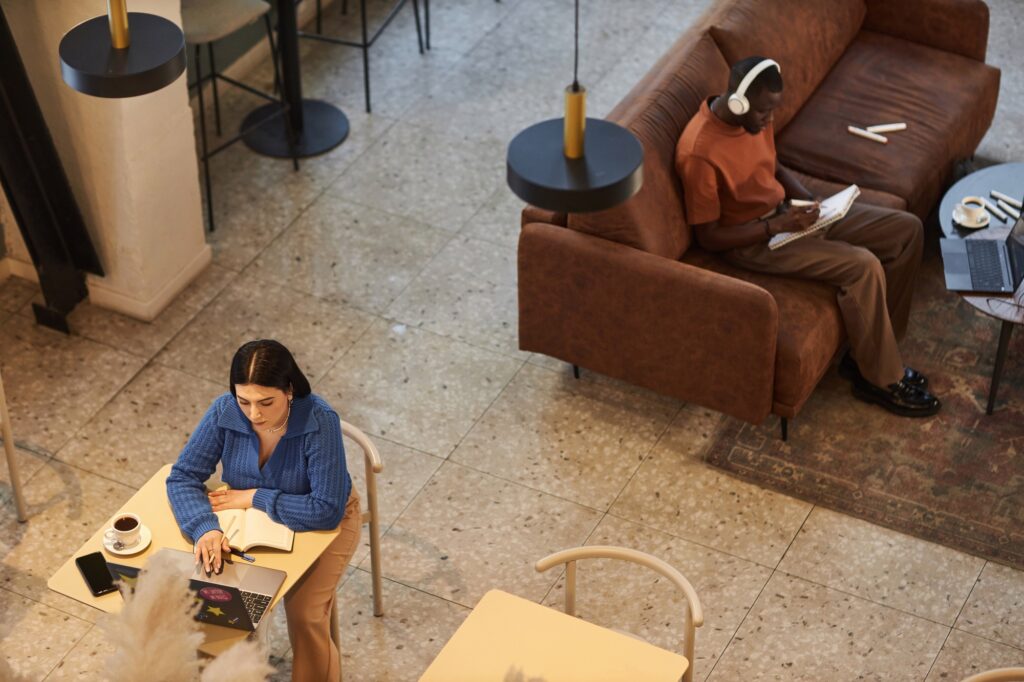 People Working in Coffee Shop Or Coworking Area in Office
